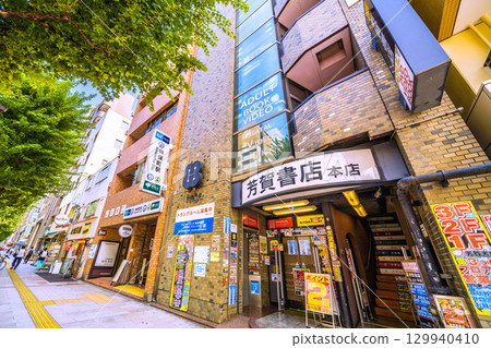 Tokyo cityscape in Japan: Kanda Jinbocho, a used bookstore district lined with shops facing north. There's a bar under the stairs... (August 21st) Tokyo cityscape in Japan: Kanda Jinbocho, a used bookstore district lined with shops facing north. There's a bar under the stairs... (August 21st) 129940410