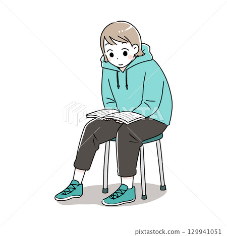 一個女人坐在椅子上看書 一個女人坐在椅子上看書 129941051