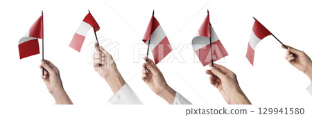 The Peru flag in hand in different angles on a white background 129941580