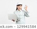 Image of an Asian woman in work clothes holding a PC and making an OK sign 129941584