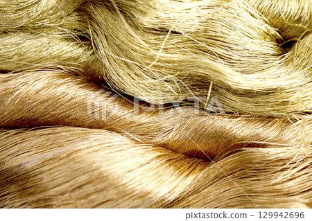 Close-up image of gold thread and slightly reddish gold thread Close-up image of gold thread and slightly reddish gold thread 129942696