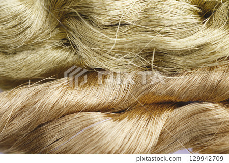 Close-up image of gold thread and slightly reddish gold thread 129942709