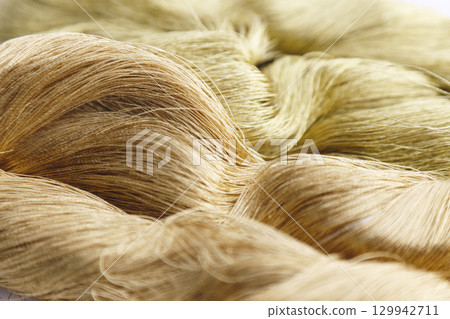 Close-up image of gold thread and slightly reddish gold thread Close-up image of gold thread and slightly reddish gold thread 129942711