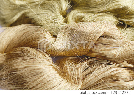 Close-up image of gold thread and slightly reddish gold thread Close-up image of gold thread and slightly reddish gold thread 129942721