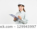 A young Asian woman in work clothes holding a board 129943997