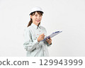 A young Asian woman in work clothes holding a board 129943999