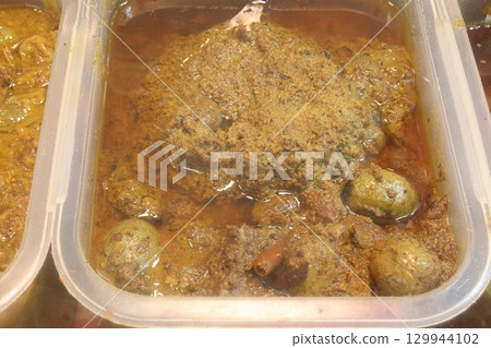 tasty pickle on pot in shop 129944102