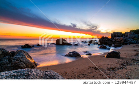Coastal Sunset in Blue and Orange with Smooth Rocks Coastal Sunset in Blue and Orange with Smooth Rocks 129944487