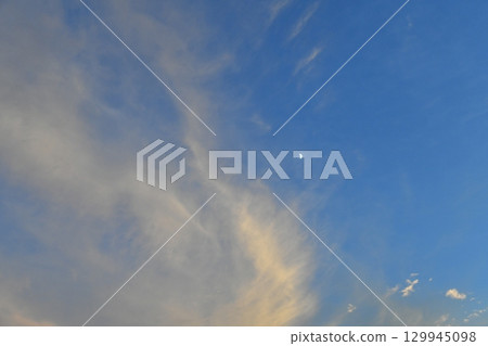 Cirrus clouds and the waxing moon Cirrus clouds and the waxing moon 129945098