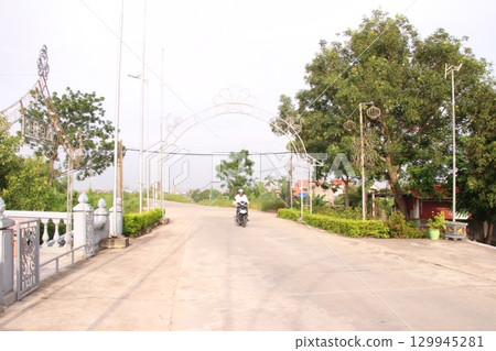rural road in vietnam with people riding bicycles and motorbikes rural road in vietnam with people riding bicycles and motorbikes 129945281