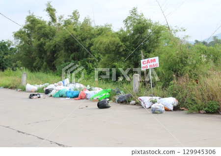 rural road in vietnam with people riding bicycles and motorbikes 129945306