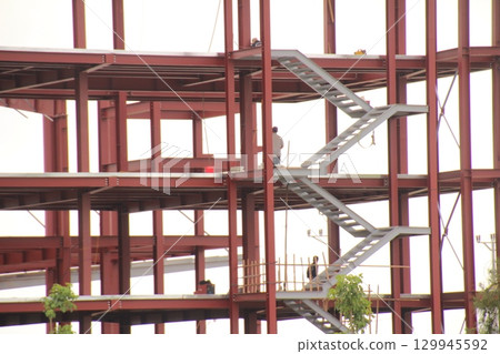 on construction site in vietnam. Construction workers. Machinery is digging the ground 129945592