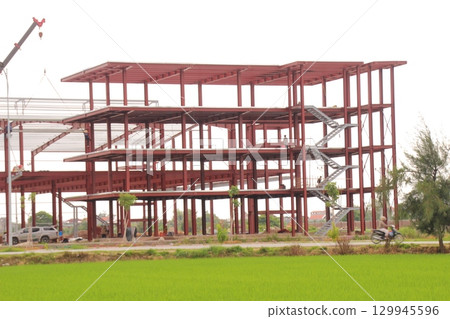 on construction site in vietnam. Construction workers. Machinery is digging the ground on construction site in vietnam. Construction workers. Machinery is digging the ground 129945596