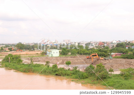 on construction site in vietnam. Construction workers. Machinery is digging the ground on construction site in vietnam. Construction workers. Machinery is digging the ground 129945599