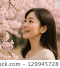 Cherry blossoms and a close-up of a smiling woman's profile 129945728