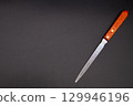 Paper knife on a black background 129946196