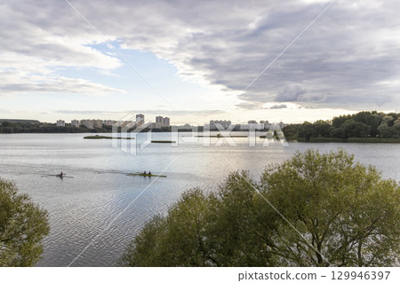 People practicing rowing on the lake. Sports People practicing rowing on the lake. Sports 129946397