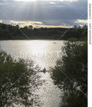 People practicing rowing on the lake. Sports People practicing rowing on the lake. Sports 129946400