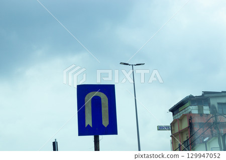 U-turn signs and traffic information installed on the road 129947052