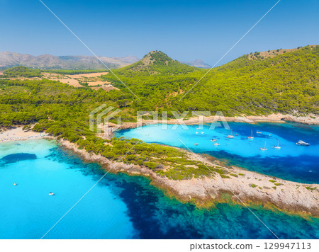 Drone view of a sea bay with turquoise transparent water. Boats and yachts. Summer vacation Drone view of a sea bay with turquoise transparent water. Boats and yachts. Summer vacation 129947113
