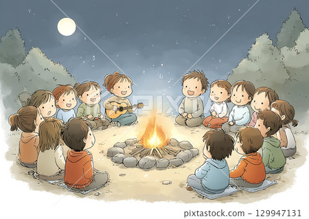 Children enjoy singing and playing games around a campfire during a school trip and overnight stay 129947131