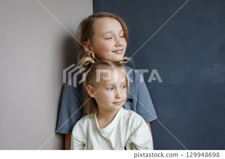 Lovely young sister and brother hugging indoor. Sibling children together portrait 129948698