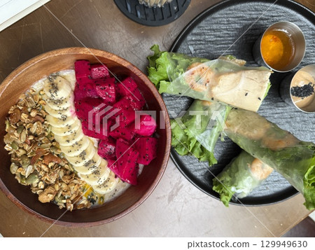 spring rolls and deep plate bowl with fruits Dragon Fruit banana granule spring rolls and deep plate bowl with fruits Dragon Fruit banana granule 129949630