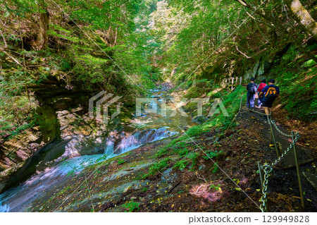 Hikers walking near the Takimidai junction of Mie Falls in Nishizawa Valley, Yamanashi City, Yamanashi Prefecture 129949828