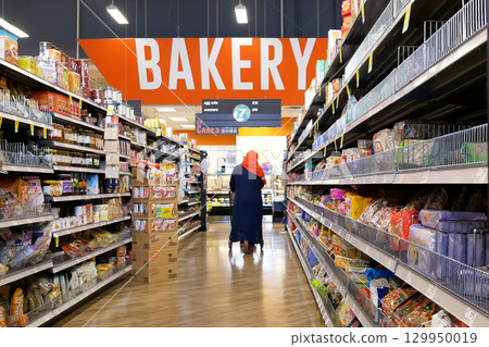 Motion of people shopping for food inside price smart foods store at barkery corridor Motion of people shopping for food inside price smart foods store at barkery corridor 129950019