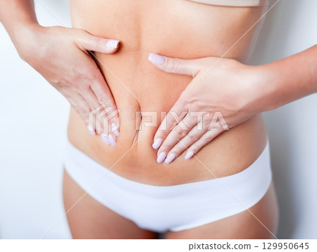 Female caucasian adult showing abdominal folds with white underwear 129950645