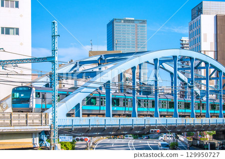 View of Tokyo cityscape in Japan, including the Keihin-Tohoku and Negishi lines (leading carriages). Base Gate Yokohama Kannai Tower is in the background. 129950727