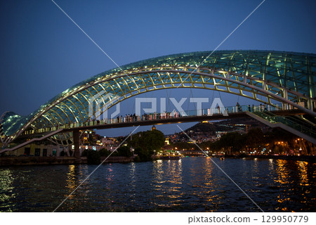 Peace bridge, steel and glass construction pedestrian bridge over Kura Mtkvari river in central Tbilisi, capital of Georgia Peace bridge, steel and glass construction pedestrian bridge over Kura Mtkvari river in central Tbilisi, capital of Georgia 129950779