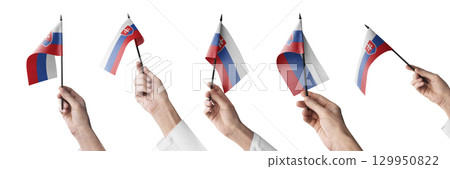 The Slovakia flag in hand in different angles on a white background 129950822