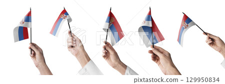 The Serbia flag in hand in different angles on a white background 129950834