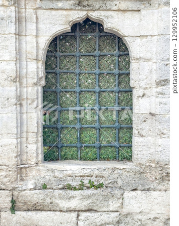 Historic stone window with lattice in Ottoman style. 129952106