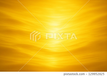 Golden abstract wavy light streaks forming smooth glowing flowing gradient design 129952825