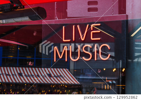 Glowing Live Music neon sign in bar window 129952862