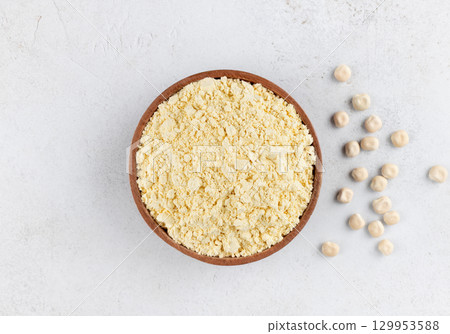 Lupines flour in a wooden bowl on a gray background. Gluten-free, protein-rich food. Top view. 129953588