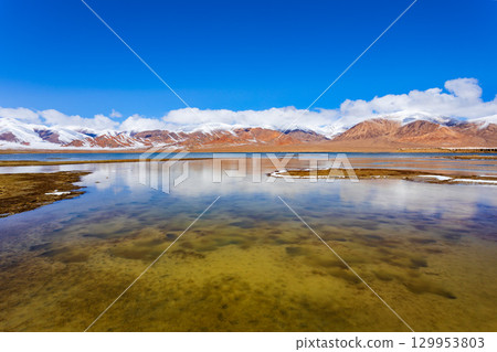 Shorkul lake and Pamir mountains near Murghab town, Tajikistan 129953803