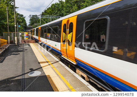 London Overground train at suburban station platform, orange livery, London, UK London Overground train at suburban station platform, orange livery, London, UK 129954078