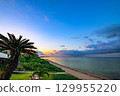 A resort scene of sandy beaches and palm trees dyed in the sunset on Ishigaki Island 129955220