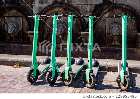 Row of Bolt green electric scooters parked in a city street in Tbilisi, Georgia Row of Bolt green electric scooters parked in a city street in Tbilisi, Georgia 129955486