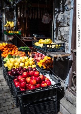 Outdoor fruit market with colorful fruits in crates Outdoor fruit market with colorful fruits in crates 129955487