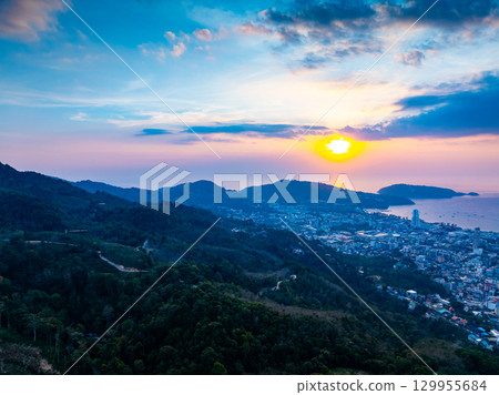 Aerial view of beautiful sunset sky over mountains with sea at Patong bay Phuket city Thailand Aerial view of beautiful sunset sky over mountains with sea at Patong bay Phuket city Thailand 129955684