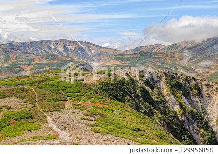 The majestic ridgeline of Mt. Kurodake and the expansive mountain scenery 129956058