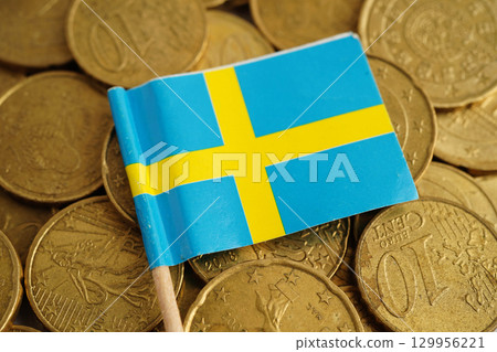 Sweden flag on coin and banknote money, finance trading investment business currency concept. Sweden flag on coin and banknote money, finance trading investment business currency concept. 129956221