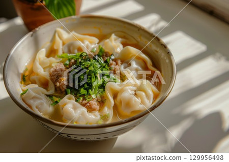 Bowl of dumplings with green onion garnish in ceramic bowl. Neural network AI generated 129956498
