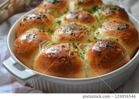 Soft garlic bread rolls with herbs in white dish. Neural network AI generated 129956546