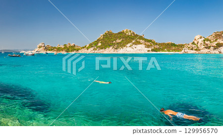 Snorkeling in clear turquoise waters of Cala Corsara on Spargi Island in Sardinia 129956570