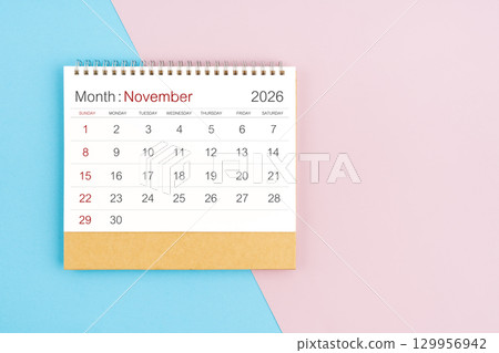 November 2026 desk calendar on blue and pink color background, with copy  space. 129956942